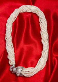Off white multi string beaded necklace with animal motif pendant along with a matching tasseled earrings only on Kalki