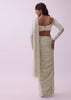 Off-White Sequins Saree And Blouse With Cowl Sleeves And Tassels