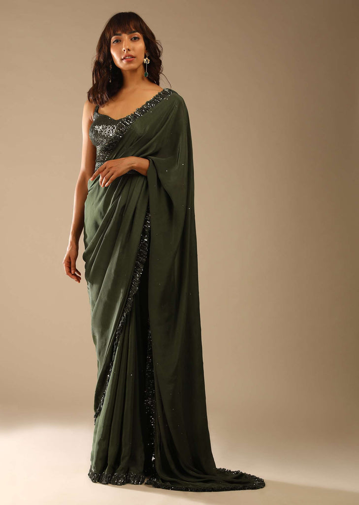 Olive Green Saree In Crepe With Sequins Ruffle On The Border, Sequins Blouse With Front Cut Out And Embellished Belt