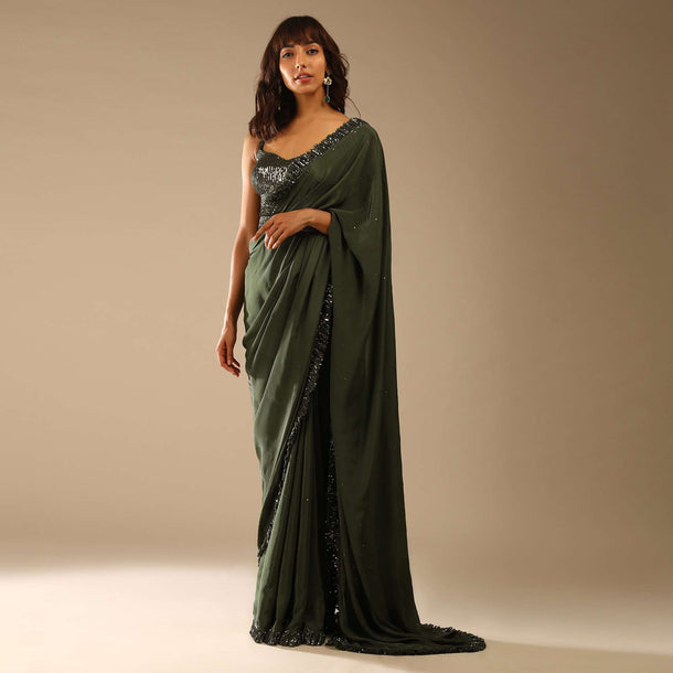 Olive Green Saree In Crepe With Sequins Ruffle On The Border, Sequins Blouse With Front Cut Out And Embellished Belt