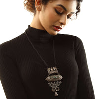 Oxidised Necklace With Black Dori Attached To A Carved Tribal Pendant Featuring Elephant Motifs And Green Stone