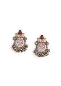 Oxidised Radha - Krishna Earrings With Carved Maroon Semi Precious Stone And Ghungru Tassels