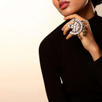 Oxidised Ring In A Half Flower Motif Studded In Mirror Work Along With Ghungru Tassels