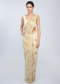 Pale cream sheer net saree with butti and embroidered scallop border only on kalki