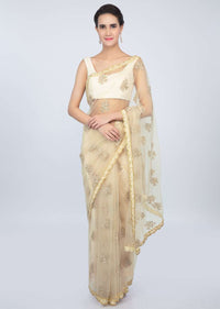 Pale cream sheer net saree with butti and embroidered scallop border only on kalki