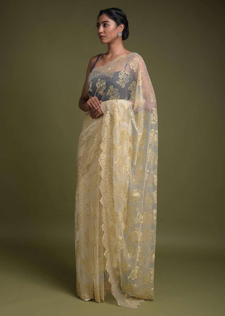 Parchment White Saree In Net With Weaved Golden Floral Motifs And Kundan Work Online - Kalki Fashion