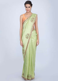 Parrot green dupion silk saree with embroidered butti and border in human and elephant motif only on Kalki