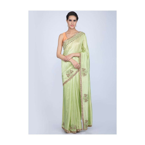 Parrot green dupion silk saree with embroidered butti and border in human and elephant motif only on Kalki