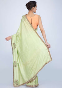 Parrot green dupion silk saree with embroidered butti and border in human and elephant motif only on Kalki