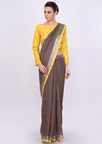 Pastel brown jute cotton saree with yellow border only on Kalki