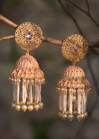 Peach And Gold Plated Jhumkas With Carved Design, Crystals And Dangling Pearl And Bead Fringes Online - Kalki Fashion