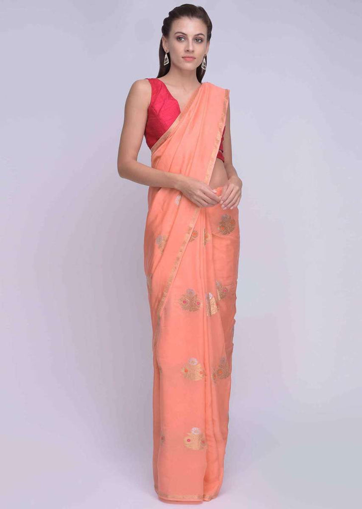 Peach dola silk saree with orange and pink tassels on the pallo only on Kalki