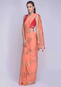 Peach dola silk saree with orange and pink tassels on the pallo only on Kalki