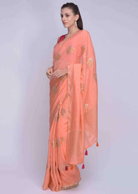 Peach dola silk saree with orange and pink tassels on the pallo only on Kalki