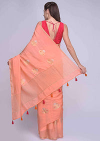 Peach dola silk saree with orange and pink tassels on the pallo only on Kalki