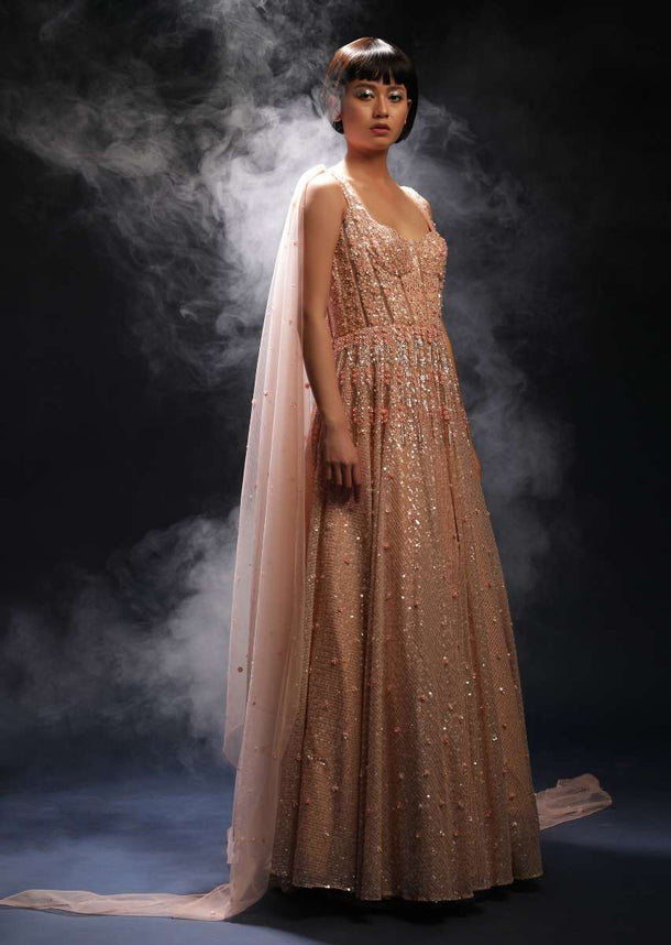 Peach Gown In Net With Flower Shaped Sequins And Cut Dana Work Along With Sheer Cut Out Detailing And Attached Cape Online - Kalki Fashion
