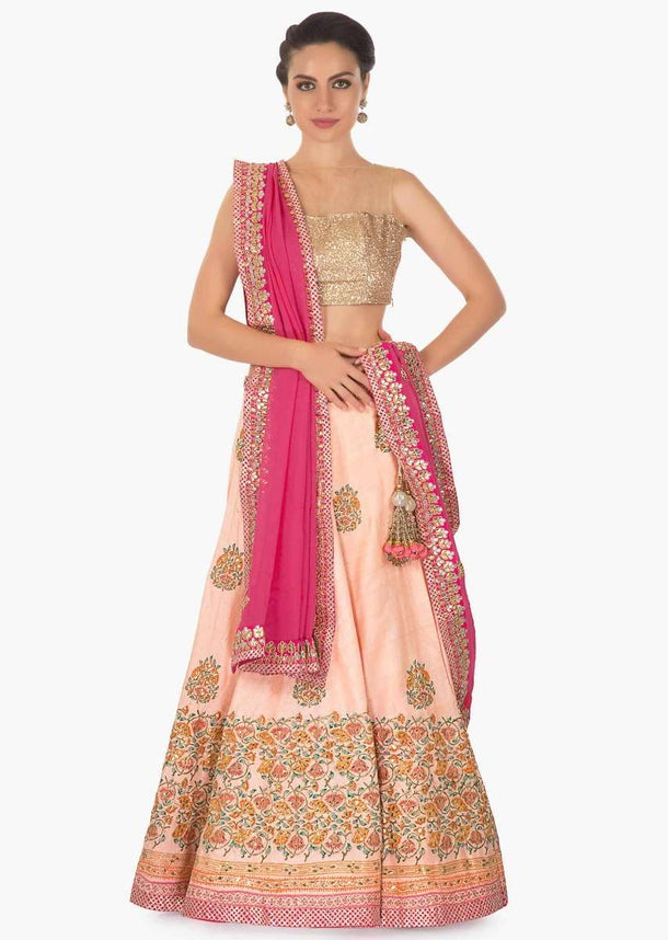 Peach raw silk lehenga with zari gotta patch work over the digital floral print design on the lehenga and on blouse