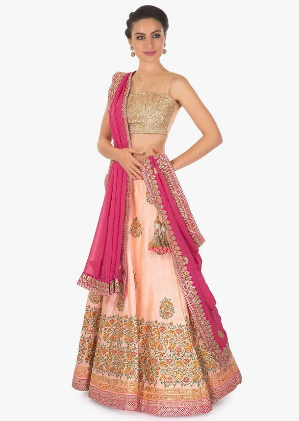 Peach raw silk lehenga with zari gotta patch work over the digital floral print design on the lehenga and on blouse