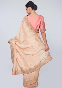 Peach raw silk saree in zari and sequins embroidered butti and border 