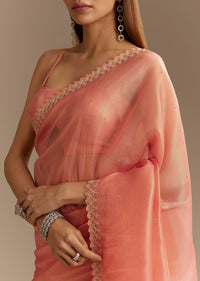 Peach Tissue Saree With Stones Cutdana Embellishments And Scallop Border