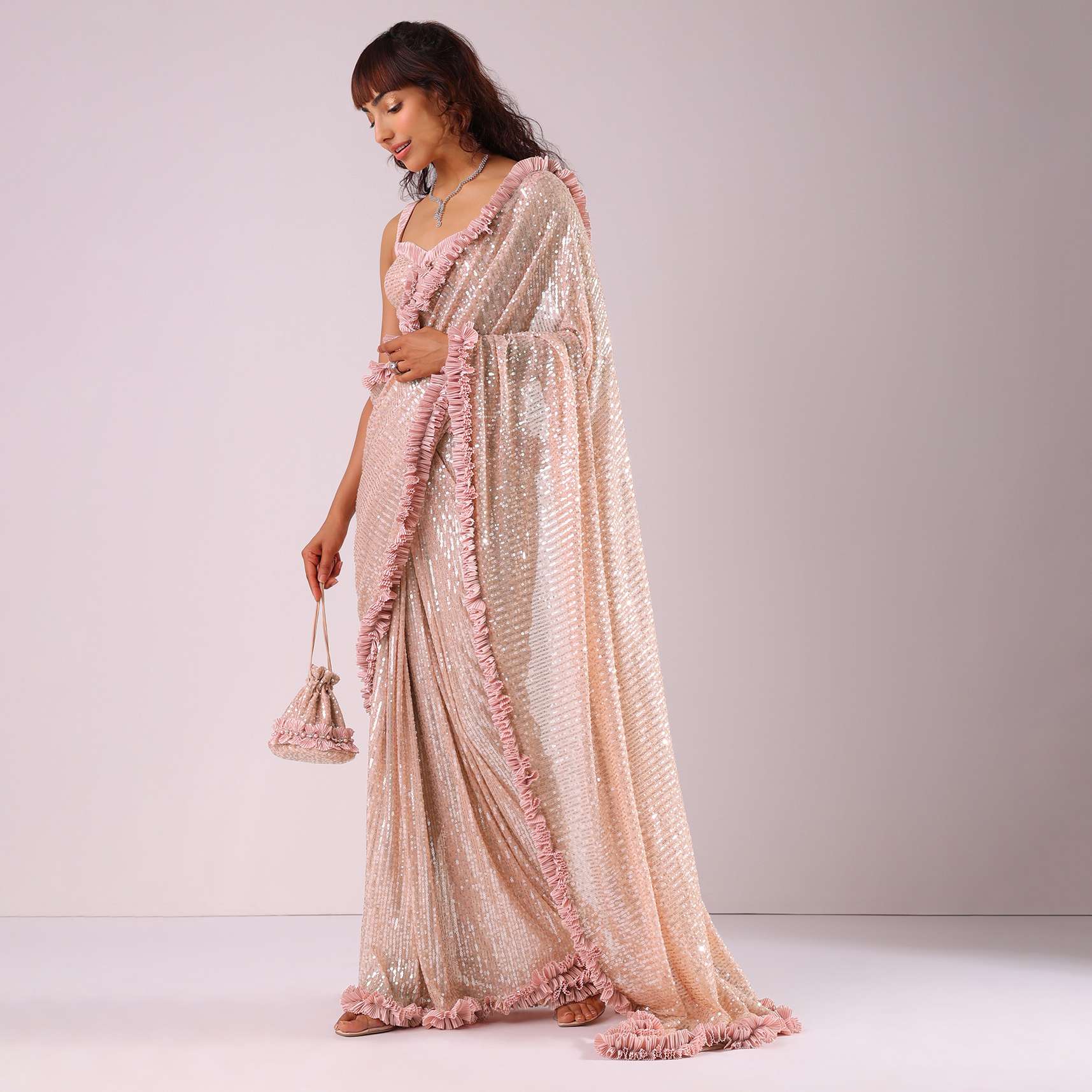 Peach Pink Ready-To-Wear Sequin Saree With Ruffle Borders And Potli