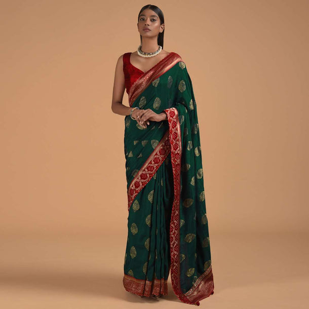 Peacock Blue Saree In Dola Silk With Brocade Leaf Shaped Buttis And Contrast Red Bandhani Border Online - Kalki Fashion