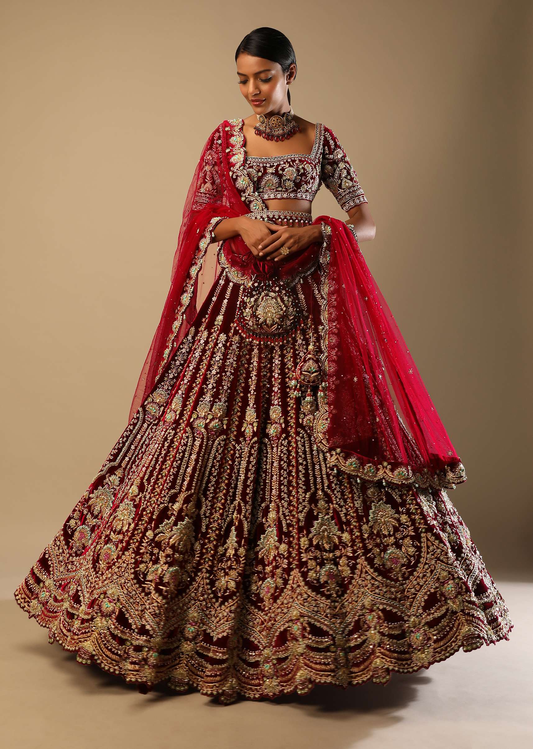 Persian Red Lehenga Choli In Velvet With Multi Colored Hand Embroidered Mughal Kalis And Floral Motifs