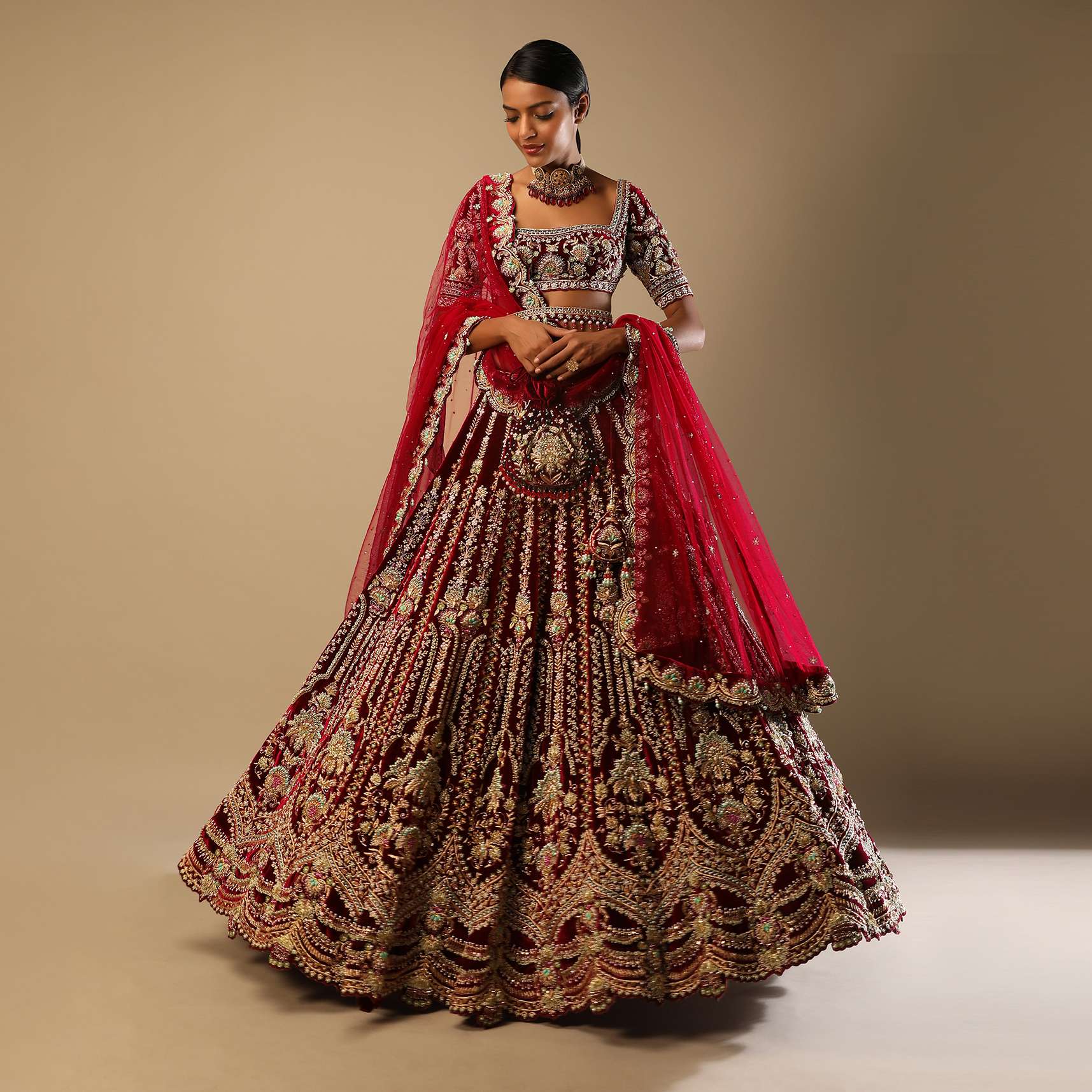 Persian Red Lehenga Choli In Velvet With Multi Colored Hand Embroidered Mughal Kalis And Floral Motifs