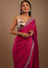 Pink Satin Saree With Heavy Stone Work On The Borders In A Floral Design
