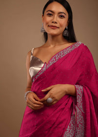 Pink Satin Saree With Heavy Stone Work On The Borders In A Floral Design