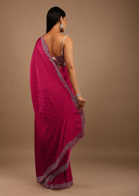 Pink Satin Saree With Heavy Stone Work On The Borders In A Floral Design