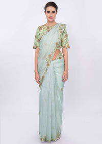 Powder blue organza saree with  contrasting pista green raw silk blouse only on kalki