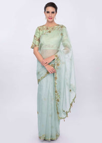 Powder blue organza saree with  contrasting pista green raw silk blouse only on kalki