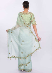 Powder blue organza saree with  contrasting pista green raw silk blouse only on kalki