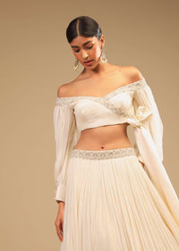 Powder White Lehenga And Off Shoulder Crop Top With Bishop Sleeves, Hand Embroidery And An Elaborate Bow