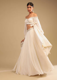 Powder White Lehenga And Off Shoulder Crop Top With Bishop Sleeves, Hand Embroidery And An Elaborate Bow