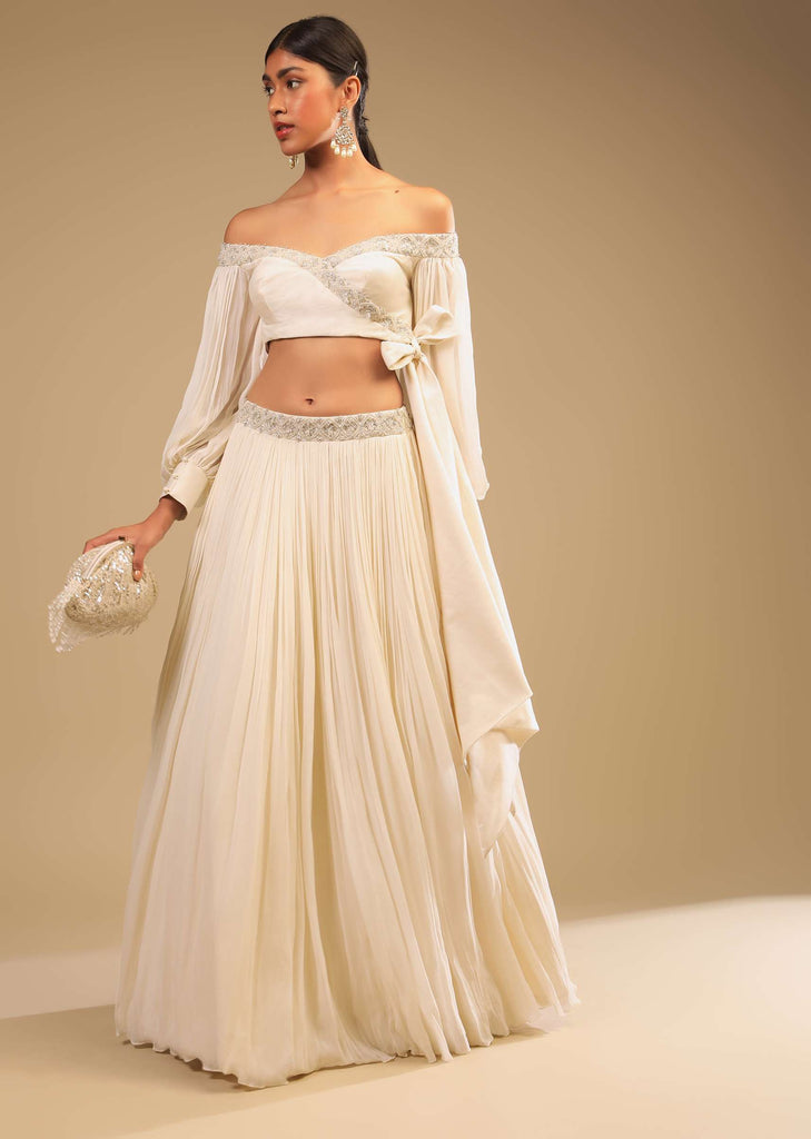 Powder White Lehenga And Off Shoulder Crop Top With Bishop Sleeves, Hand Embroidery And An Elaborate Bow