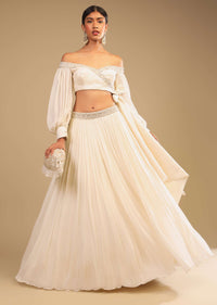 Powder White Lehenga And Off Shoulder Crop Top With Bishop Sleeves, Hand Embroidery And An Elaborate Bow