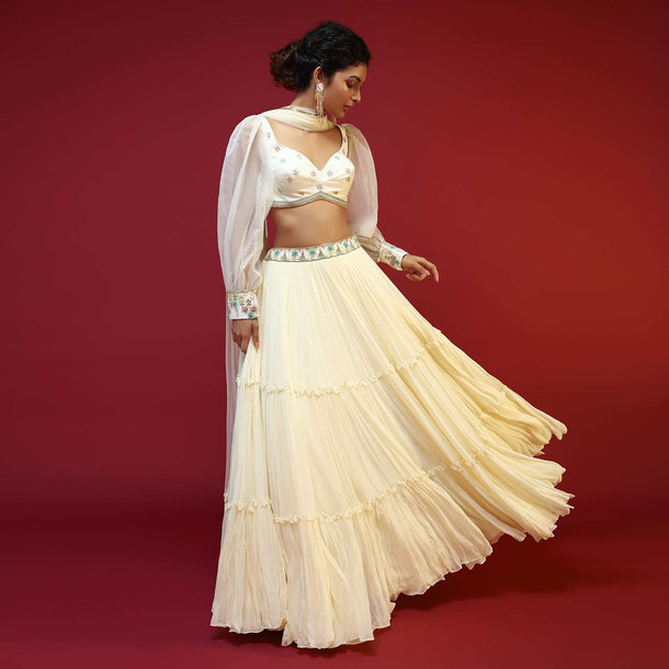 Powder White Lehenga Choli With Elaborate Balloon Sleeves And Multi Colored Hand Embroidered Buttis