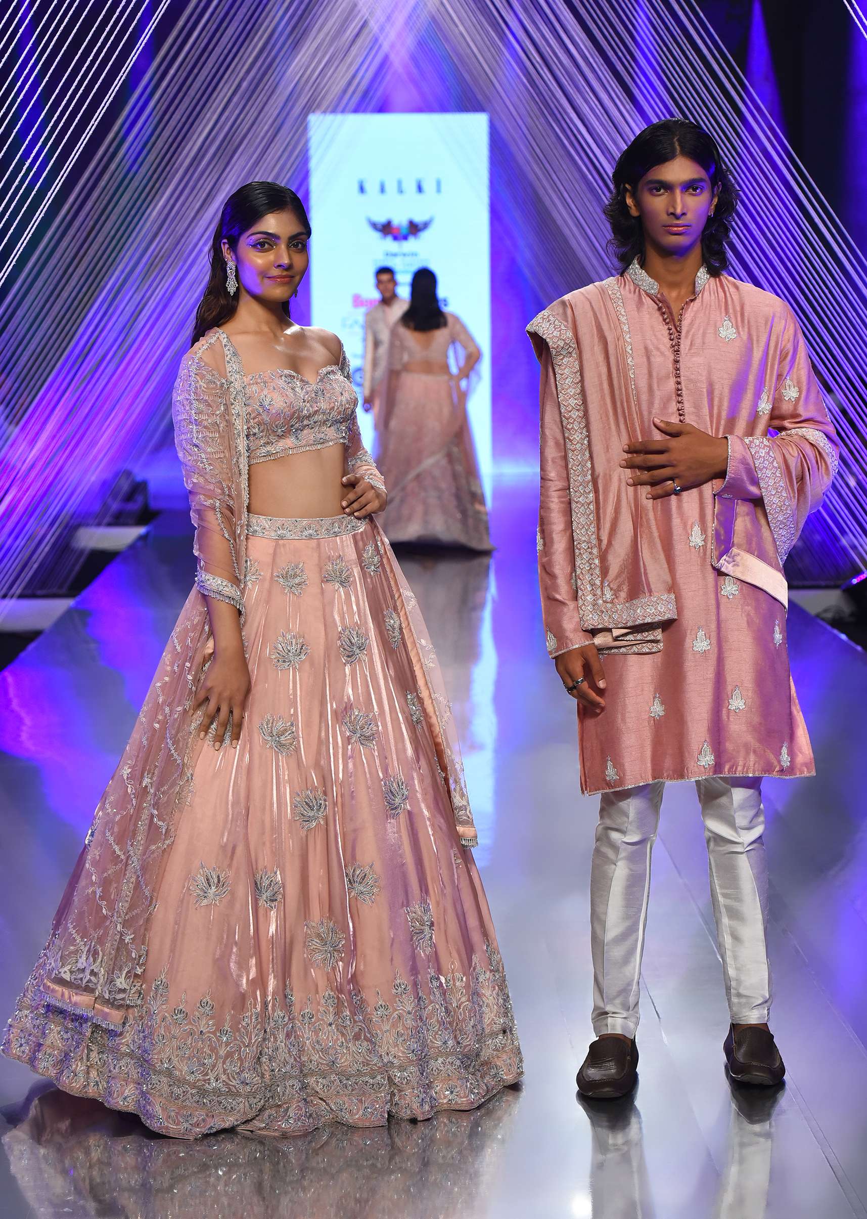 Powder Pink Lehenga And Off Shoulder Crop Top In 3D Floral Motifs Embroidery, Matching Net Dupatta With Stone Fringes