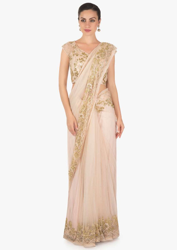 Powder pink net saree featuring in cutdana embroidery