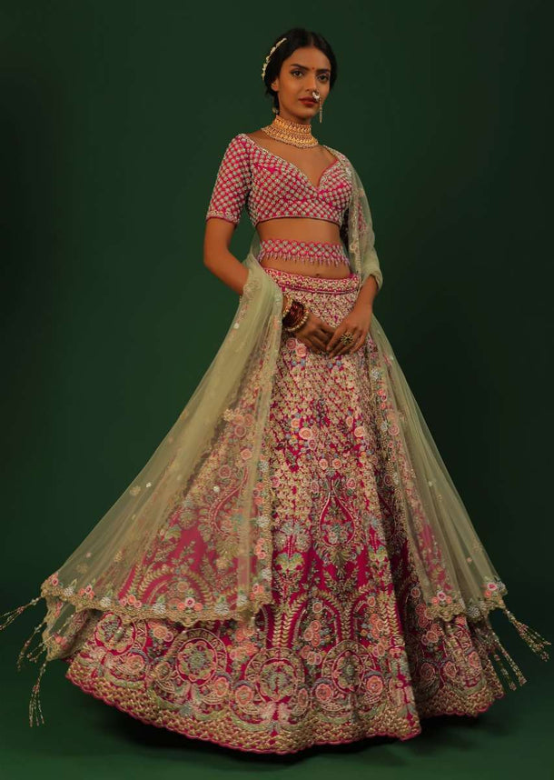 Rani Pink Lehenga Choli In Raw Silk With Heavy Embroidered Kalis Using Colorful Resham And Cut Dana In Floral Motifs Online - Kalki Fashion