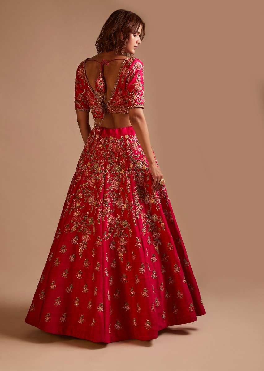 Rani Pink Lehenga Choli In Raw Silk With Hand Embroidered Cluster Of Flowers Cascading Into Floral Buttis