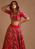 Rani Pink Lehenga Choli In Raw Silk With Hand Embroidered Cluster Of Flowers Cascading Into Floral Buttis