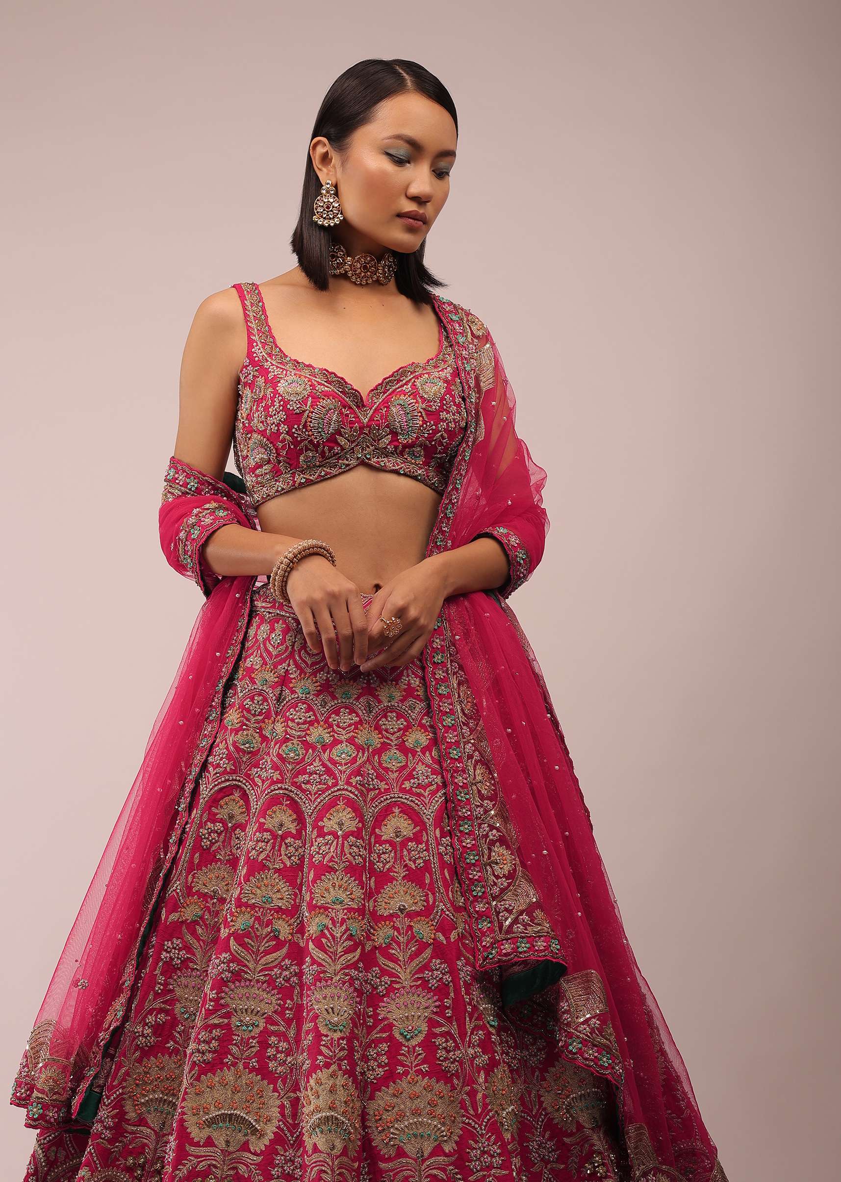 Rani Pink Lehenga In Golden Zari Work Embroidery Inspired By Mughal Architecture With Matching Net Dupatta In Embroidered Buttis