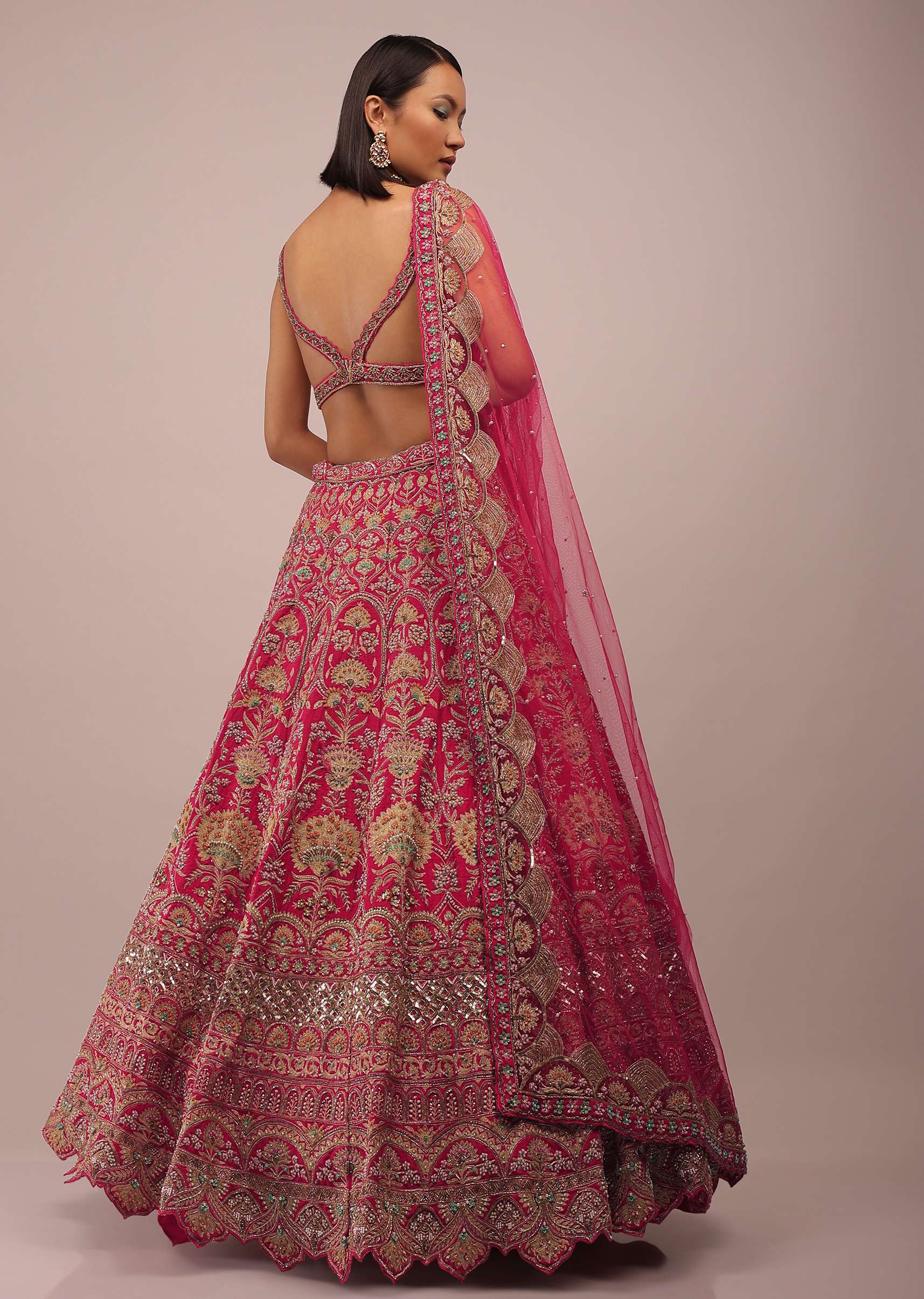 Rani Pink Lehenga In Golden Zari Work Embroidery Inspired By Mughal Architecture With Matching Net Dupatta In Embroidered Buttis