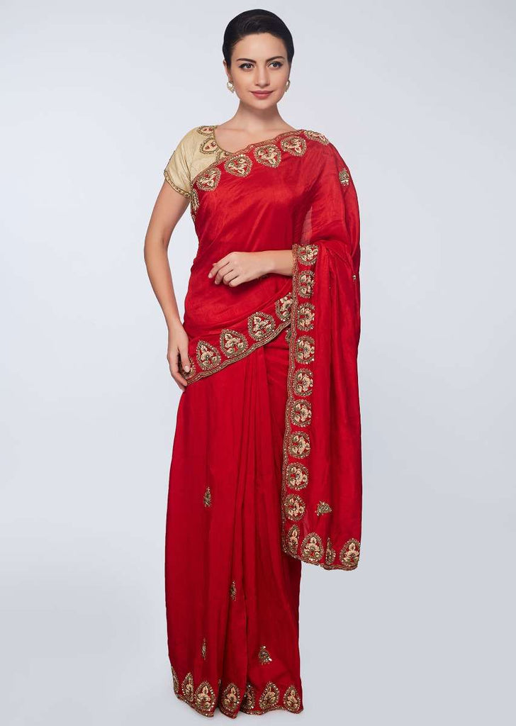 Red cotton silk saree in embroidered butti and border