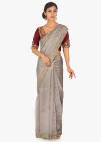 Red raw silk embellished blouse  paired with grey organza saree