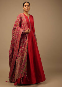 Red Anarkali Suit In Raw Silk With Hand Embroidery And A Brocade Dupatta Enhanced With Bandhani