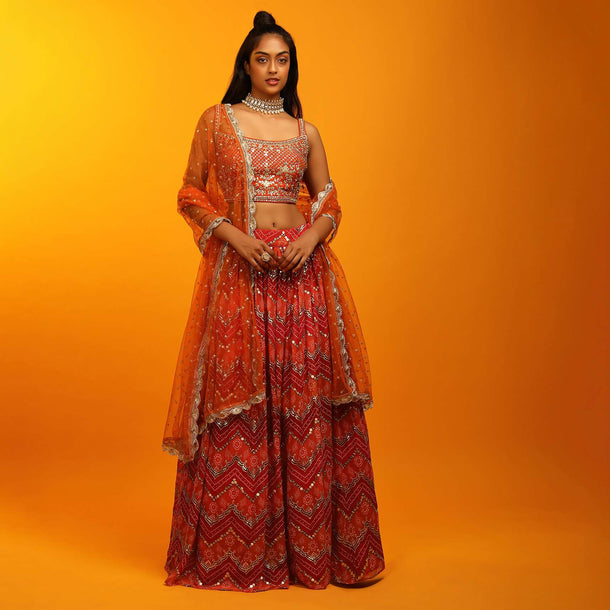 Red And Burnt Orange Lehenga In Georgette With Chevron And Bandhani Print And Mirror Embroidered Choli